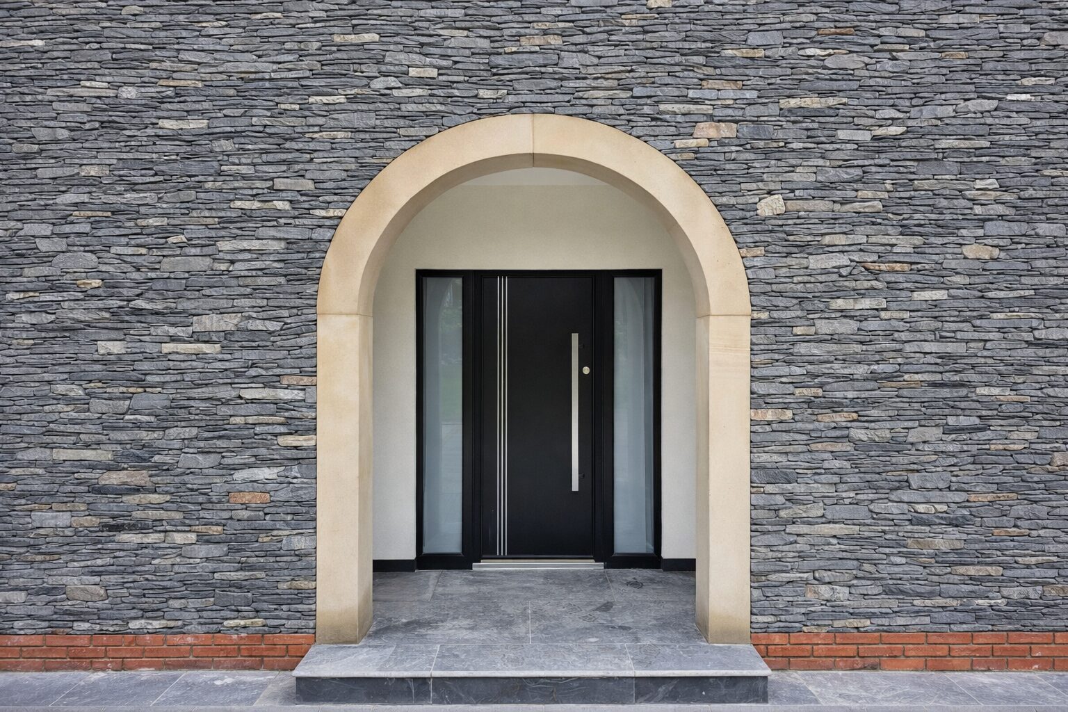 Home Black composite front door with a long bar handle, set in a stone arch