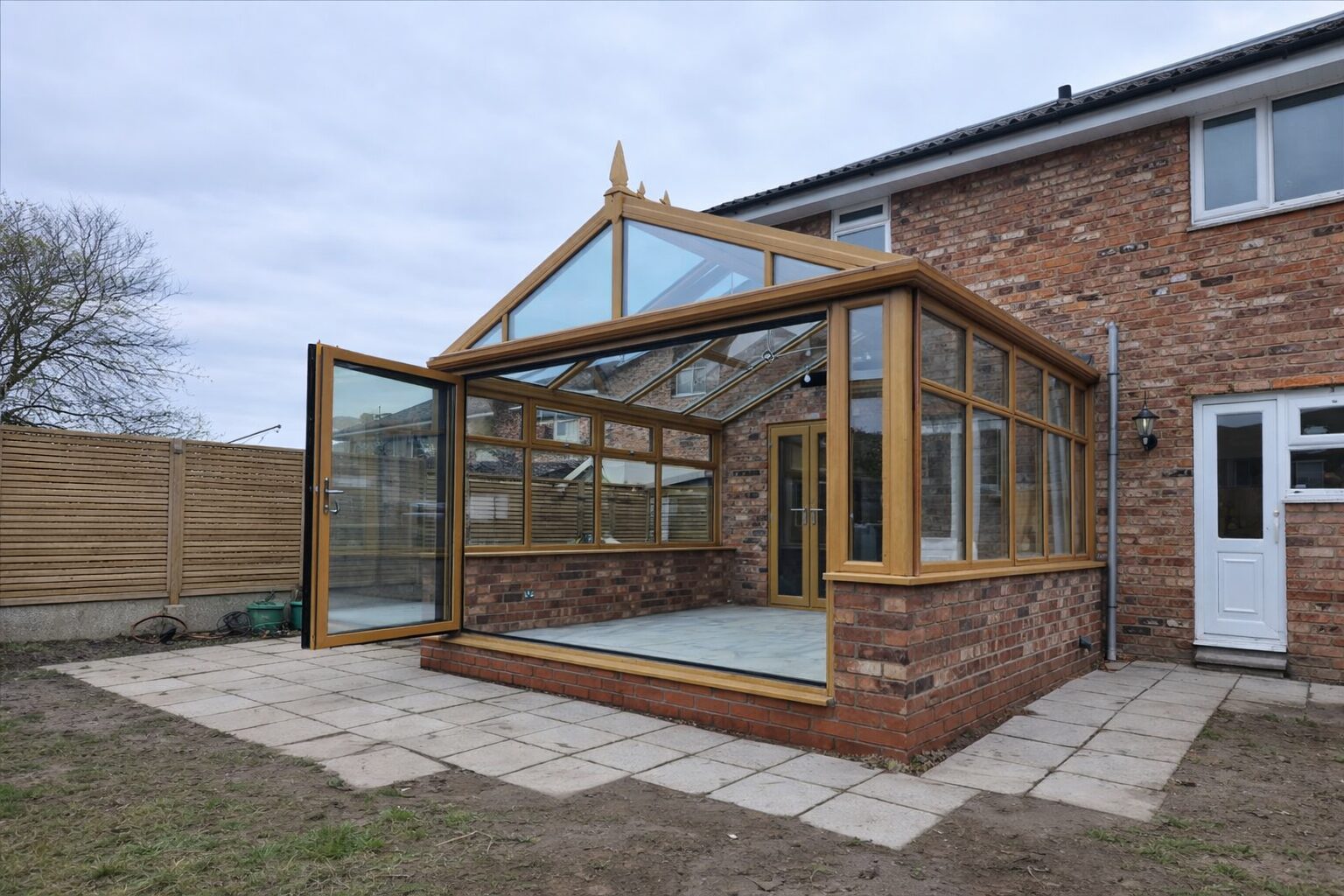 Home Oak-effect conservatory with a gable roof