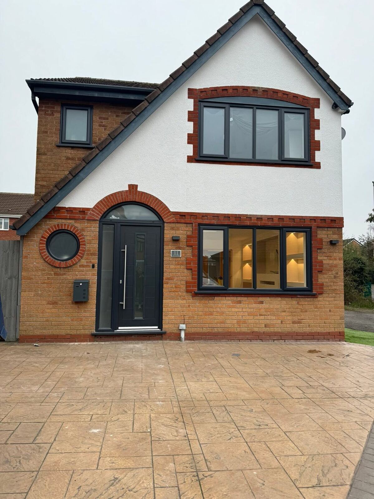 Home Dark composite front door on a rendered house
