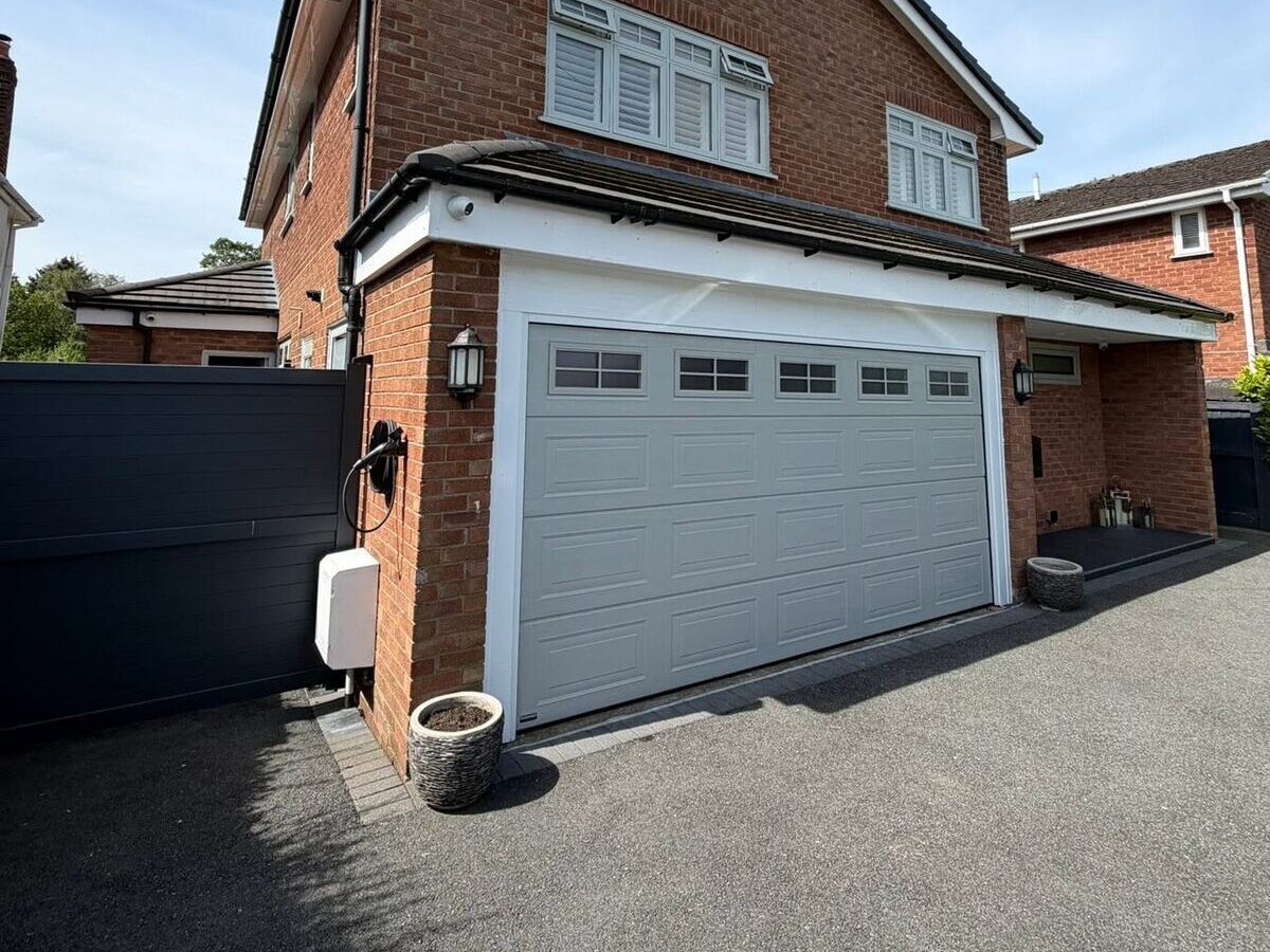 Home Detached house with a white sectional garage door