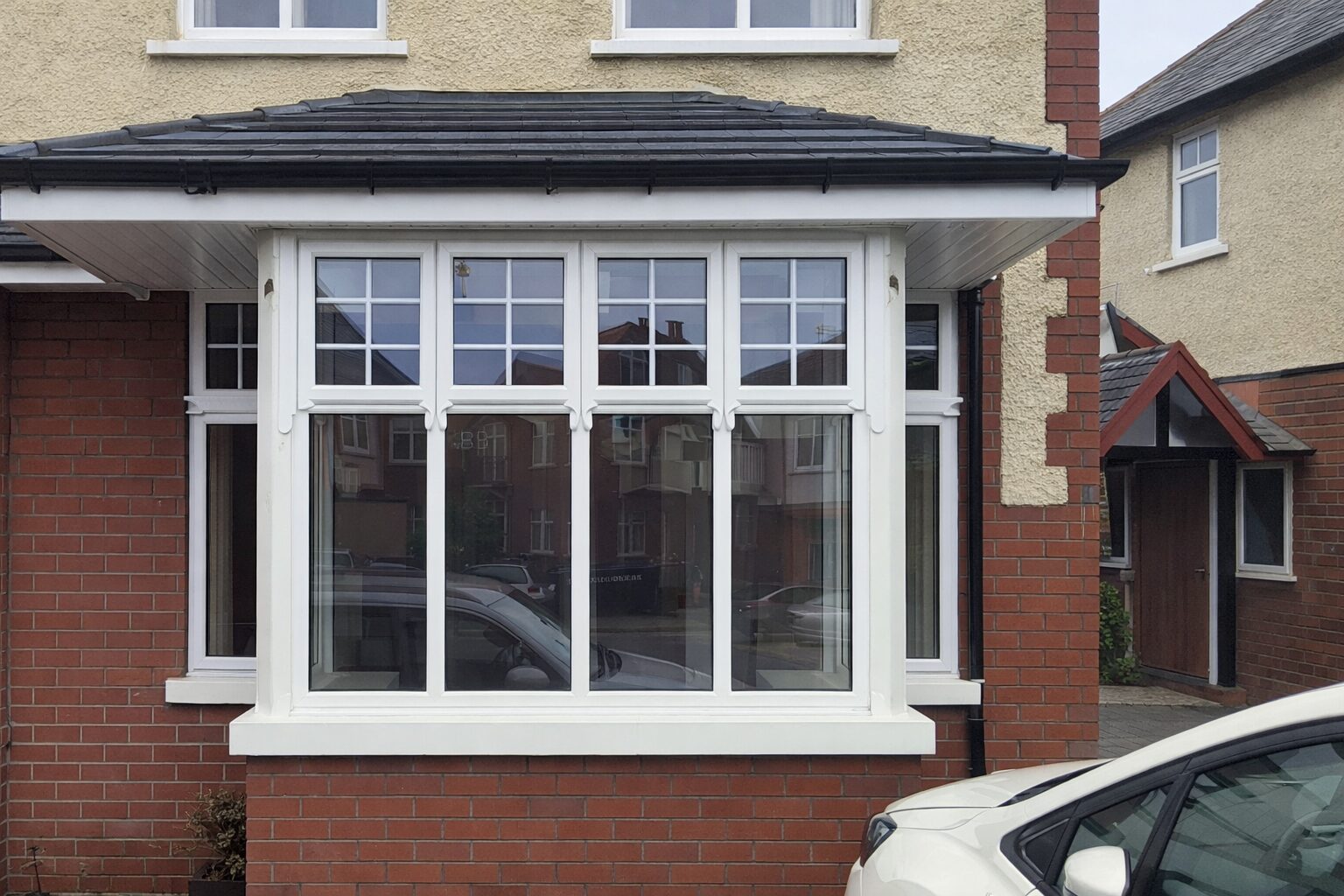 Home White uPVC bay window on a red brick house